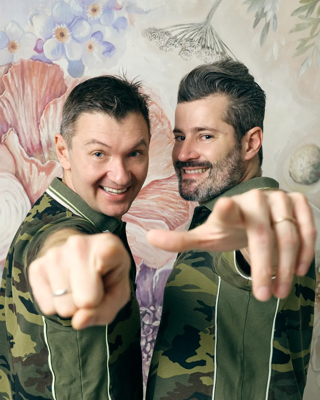 Simone Kravos e Francesco Guadagno, in polo mimetica, indicano chi guarda